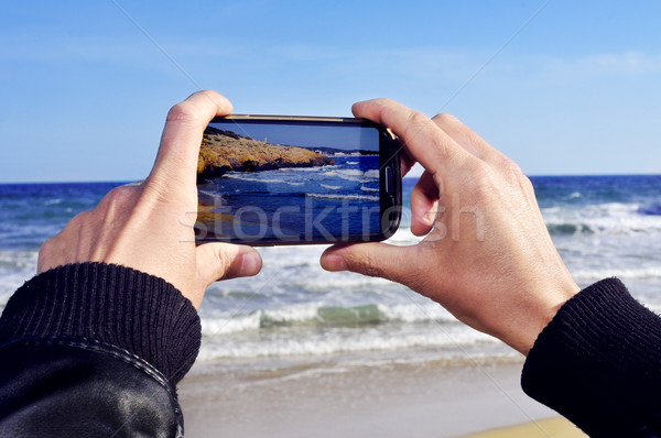 someone taking a picture of a beach with a smartphone Stock photo © nito