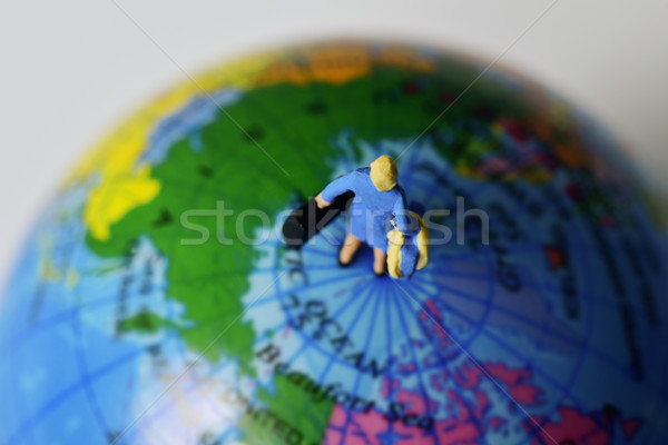 miniature traveler woman on the top the world Stock photo © nito