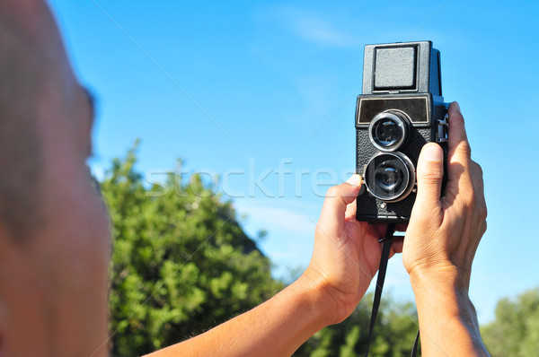 young man taking a selfie with an old medium format camera Stock photo © nito