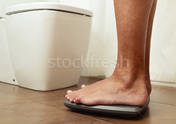 young man standing on a scale Stock photo © nito
