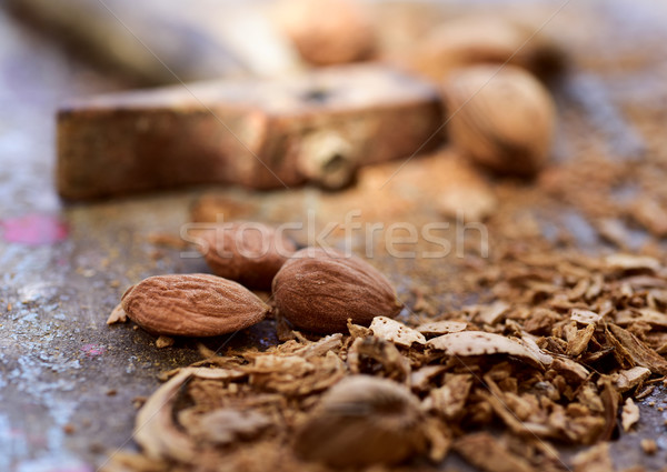 Stock photo: cracked almonds and hammer