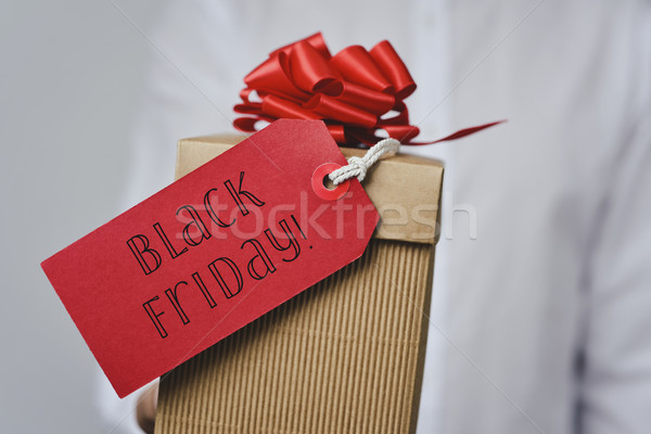 man with a gift box with the text black friday Stock photo © nito