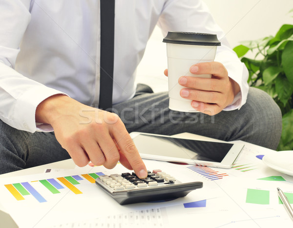 young businessman using a calculator Stock photo © nito