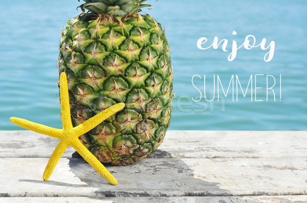 pineapple and starfish on a pier and text enjoy summer Stock photo © nito