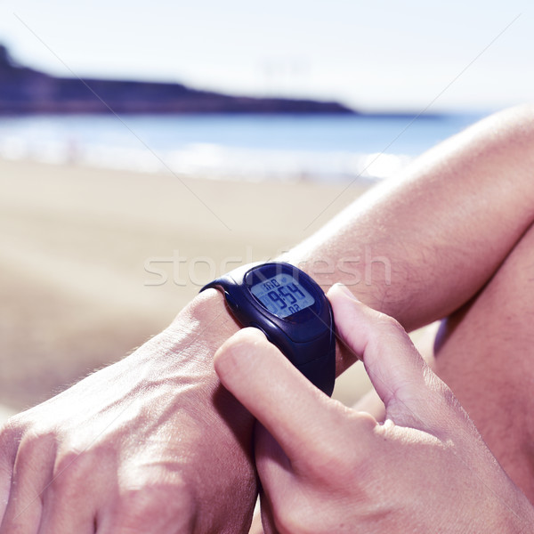 young sportsman syncing his smartwatch Stock photo © nito
