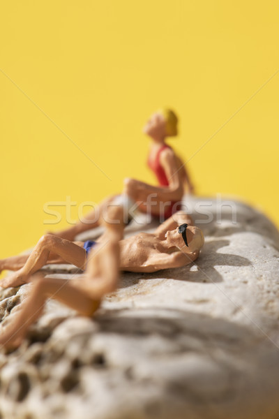 miniature people sunbathing on a rock Stock photo © nito