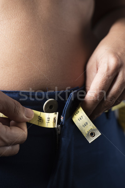 young woman trying to fasten her trousers Stock photo © nito