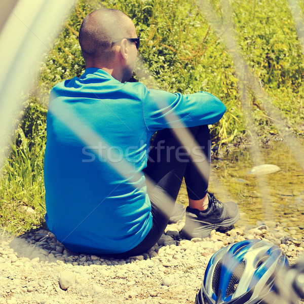 cyclist getting some rest at the riverside with a retro filter e Stock photo © nito