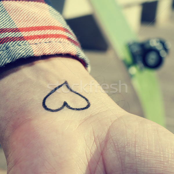 young man with a heart tattooed in his wrist Stock photo © nito