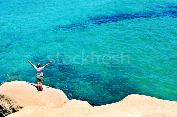 man with the arms in the air in front of the ocean Stock photo © nito