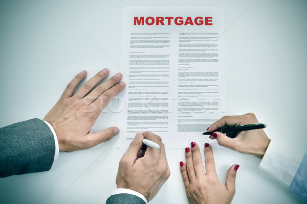 man and woman signing a mortgage loan contract Stock photo © nito