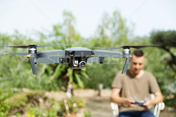 man operating a drone in a natural landscape Stock photo © nito