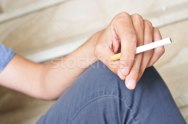 young man with an unlit cigarette in his hand Stock photo © nito