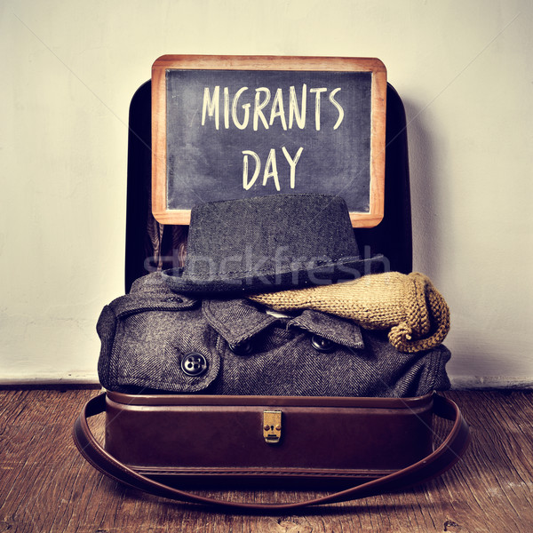 old suitcase with some clothing and chalkboard with text migrant Stock photo © nito