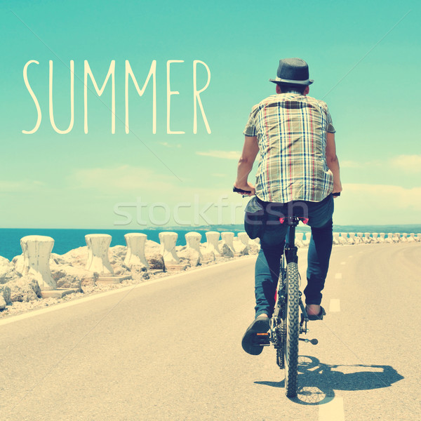 young man riding a bike and text summer, with a filter effect Stock photo © nito