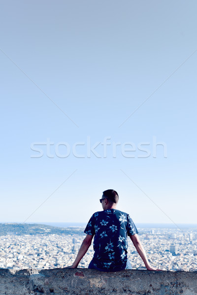 young man with the city bellow him Stock photo © nito