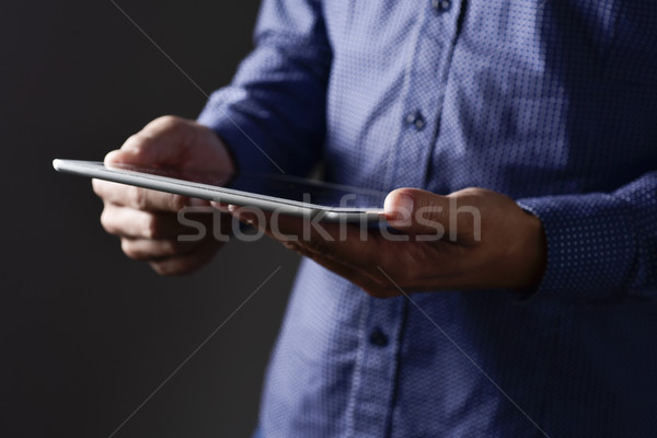 young man using his tablet computer Stock photo © nito