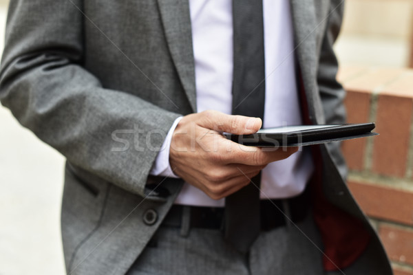 young businessman using a tablet outdoors Stock photo © nito