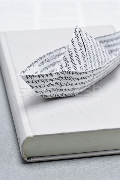 Stock photo: paper boat on an open book
