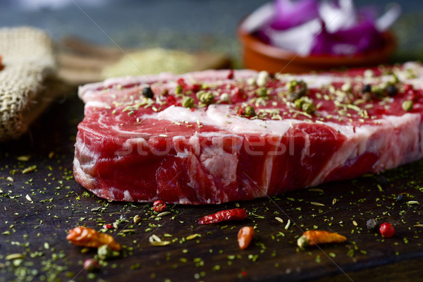 raw strip steak seasoned with different spices Stock photo © nito