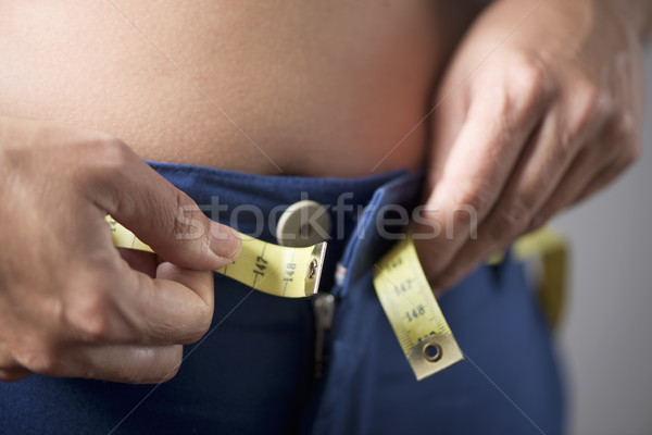 young woman trying to fasten her trousers Stock photo © nito