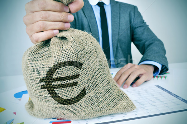 young man in suit with a burlap money bag with the euro sign Stock photo © nito