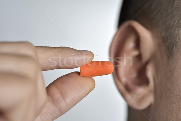 man putting on an earplug Stock photo © nito