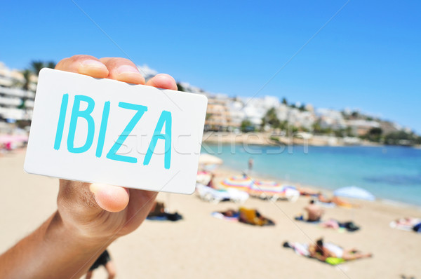 man with a signboard with the word Ibiza, in Ses Figueretes Beac Stock photo © nito