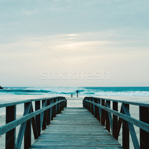 boardwalk and man taking a picture on the beach Stock photo © nito