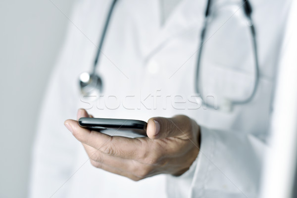 doctor man using a smartphone Stock photo © nito