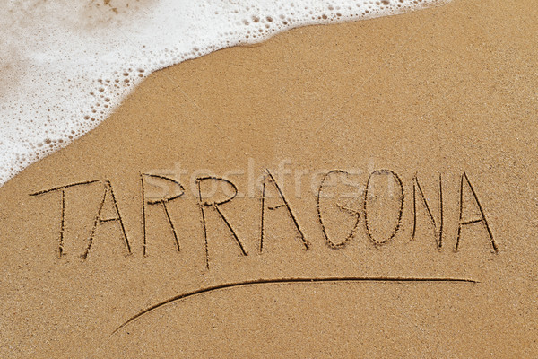 word Tarragona written in the sand of a beach Stock photo © nito