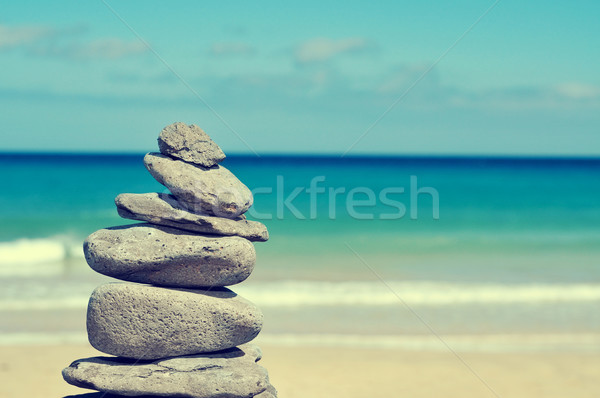 balanced stones in a white sand beach, with a cross-processed ef Stock photo © nito
