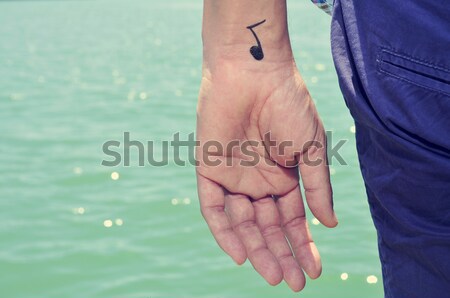 man making the V sign, with a bracelet patterned as the rainbow  Stock photo © nito