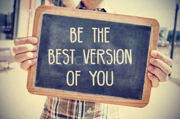 young man with a chalkboard with the text be the best version of Stock photo © nito