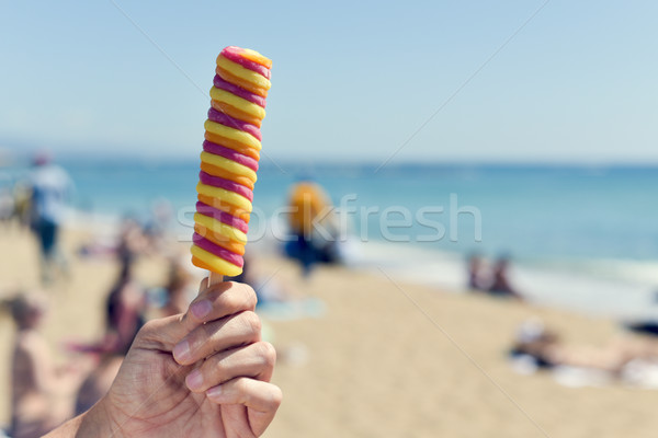 man eating a popsicle on the beach Stock photo © nito