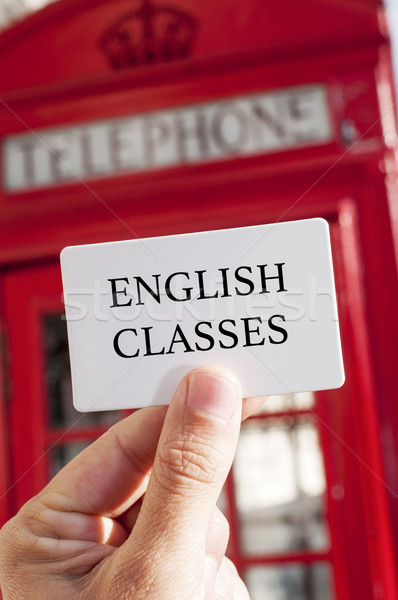 text english classes in a signboard and a red telephone booth in Stock photo © nito