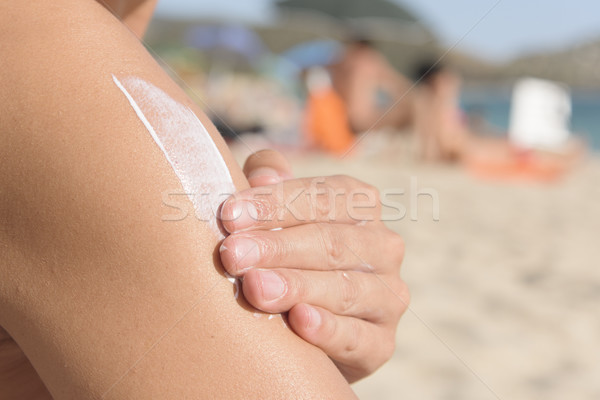 man applying sunscreen to himself Stock photo © nito