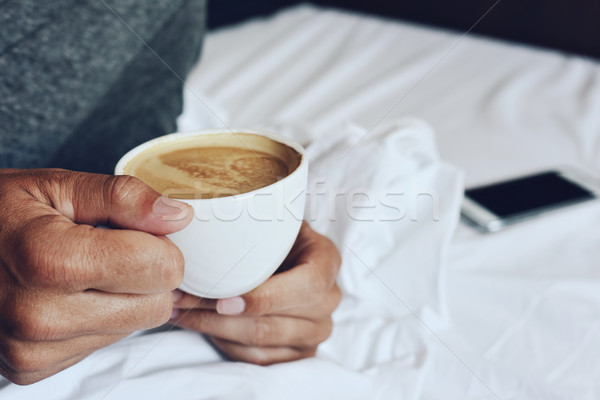 young man having a coffee in bed Stock photo © nito