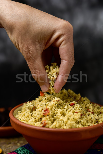 young man eating tabbouleh with his hand Stock photo © nito