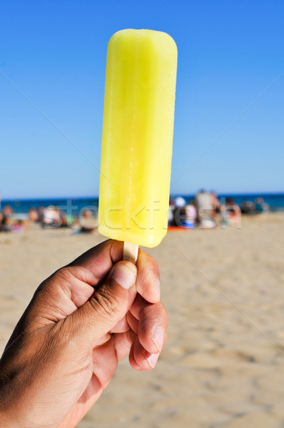 closeup of a man with an ice pop on the beach Stock photo © nito