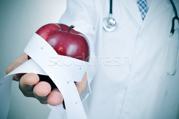 doctor man with a red apple and a measuring tape Stock photo © nito