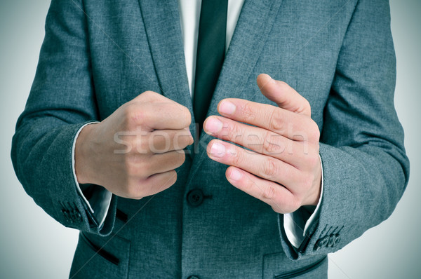 Férfi öltöny kézmozdulat visel iroda munka Stock fotó © nito