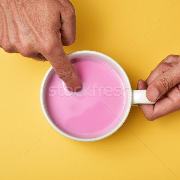 man soaking his finger in a pink milkshake Stock photo © nito