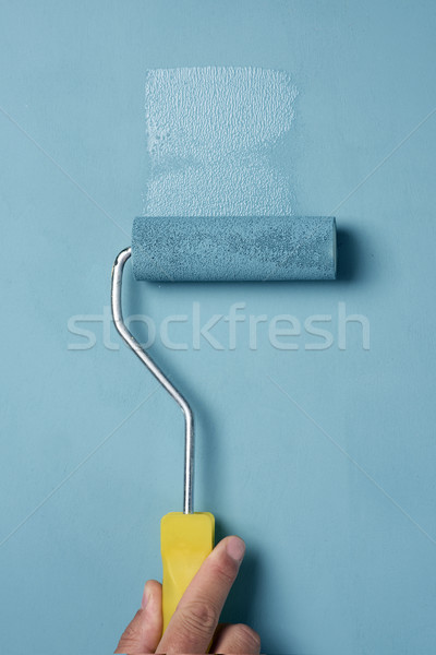young man painting with a paint roller Stock photo © nito