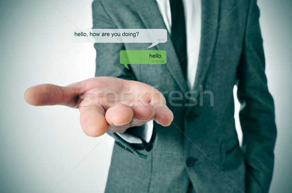 Azonnali üzenetküldés férfi visel öltöny chat Stock fotó © nito