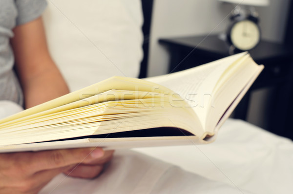young man reading a book in bed Stock photo © nito
