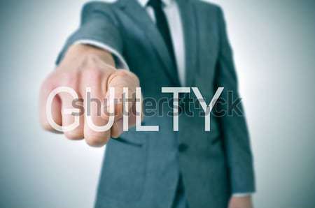 Bűnös férfi visel öltöny mutat ujj Stock fotó © nito