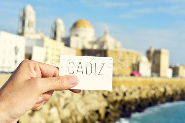 man shows a signboard with the word Cadiz, in Cadiz, Spain Stock photo © nito