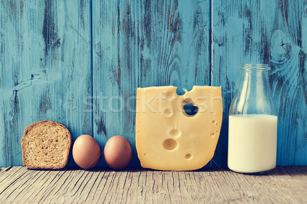 Stock photo: toast, eggs, cheese and milk on a rustic wooden table, with a fi
