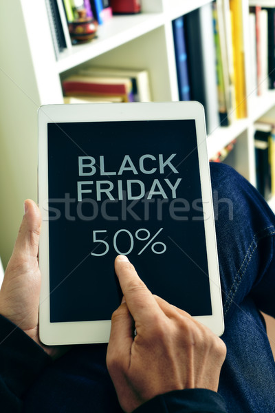 man with a tablet with the text black friday Stock photo © nito